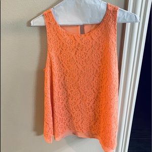 Tunic tank, color is tangerine, flares out at the bottom, very flattering